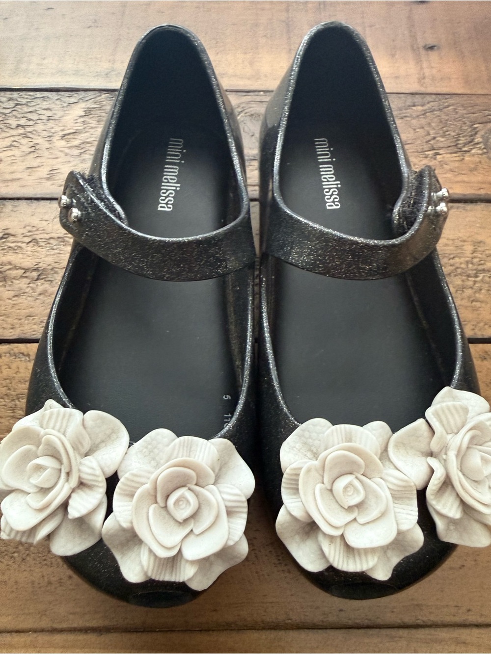 Mini Melissa Black Glitter Mary Janes with Cream Flower Appliqués